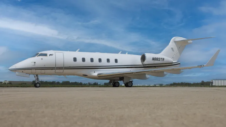 Bombardier Challenger 300 parked on tarmac.