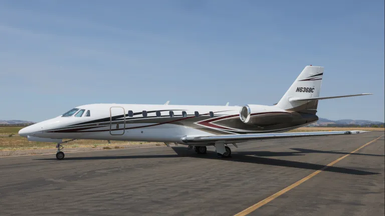 Exterior profile of a Cessna Citation Sovereign on a tarmac with a blue sky in the background