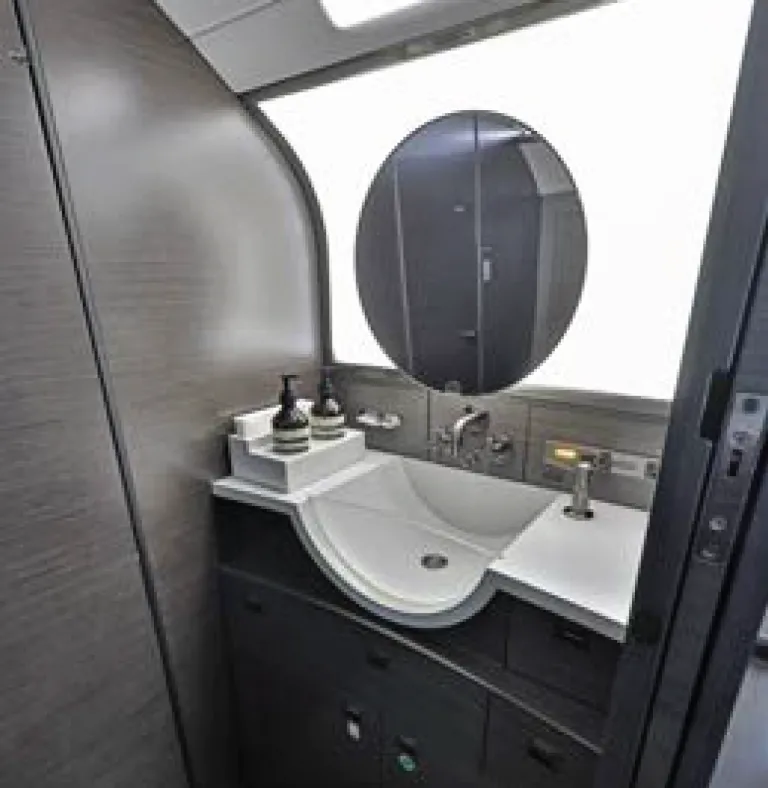 Bombardier Challenger 300 interior sink and round mirror.