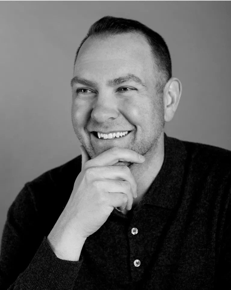 Black and white smiling portrait of Jonathan Gardner.