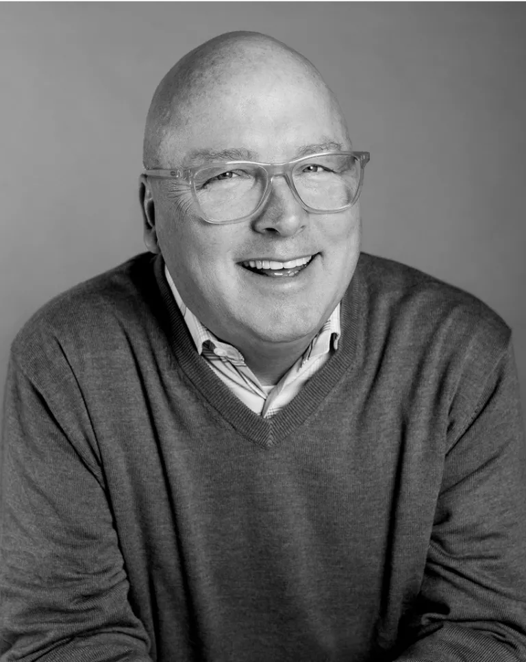 Black and white smiling portrait of Troy Lawson.
