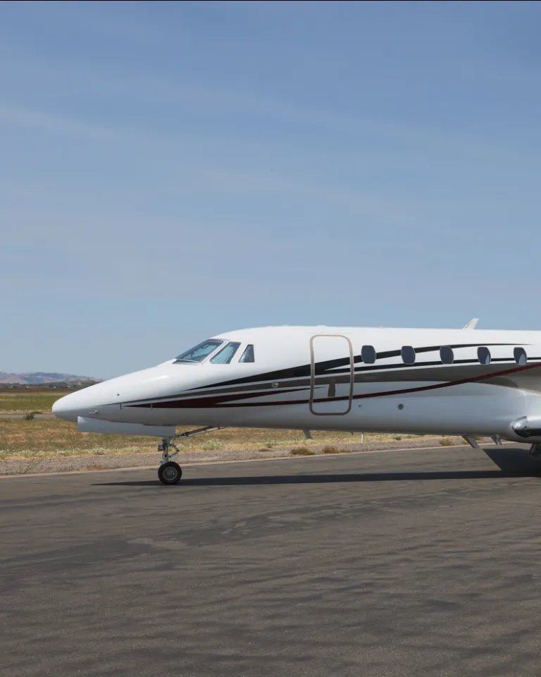 Exterior profile of a Cessna Citation Sovereign on a tarmac with a blue sky in the background